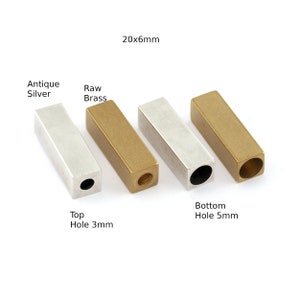 May include: Four metal bar pendants, two in antique silver and two in raw brass. Each bar is 20mm x 6mm with a 3mm hole at the top and a 5mm hole at the bottom.