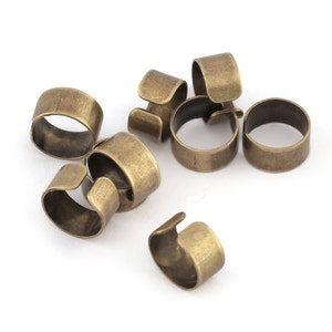 May include: A set of seven antique gold-toned metal rings. The rings are open and have a slightly curved shape.