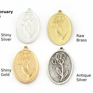Pode incluir: Quatro pingentes de metal de forma oval com um design de flor de íris gravado. Os pingentes estão disponíveis em quatro acabamentos: prata brilhante, ouro brilhante, latão bruto e prata antiga.