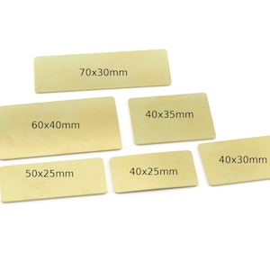 May include: Five rectangular pieces of light brown craft paper with different dimensions written on them in black ink. The dimensions are 70x30mm, 60x40mm, 40x35mm, 40x25mm, and 40x30mm.