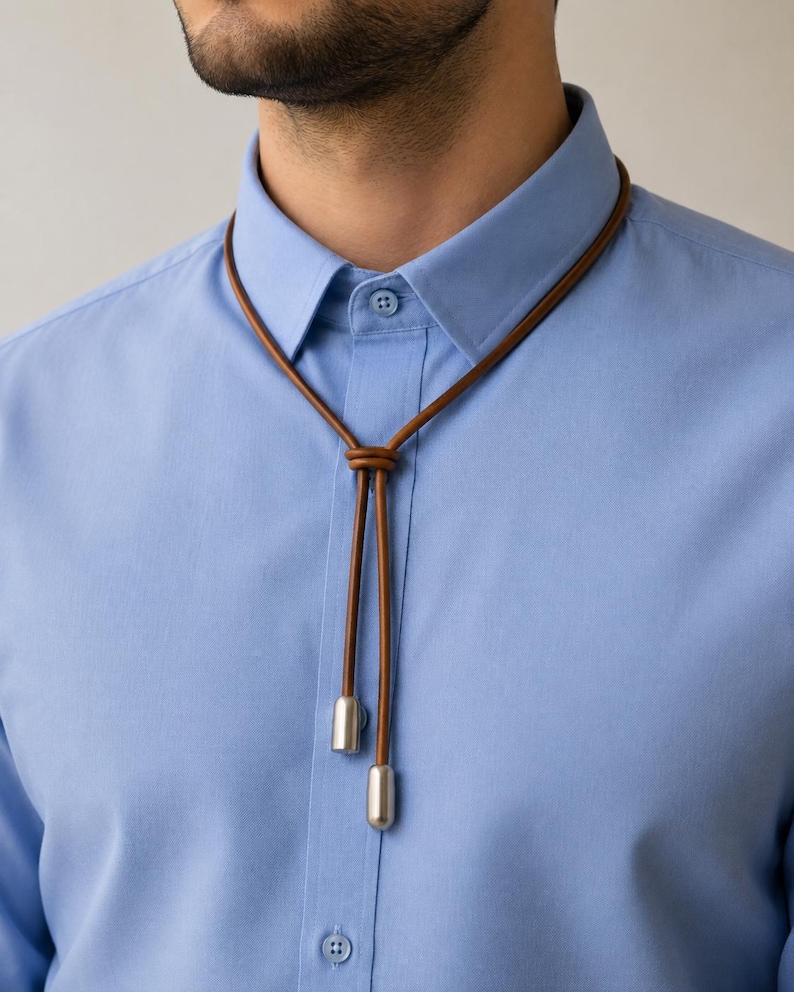 Parliament blue shirt with brown leather bolo style necklace featuring light antique silver cord end caps