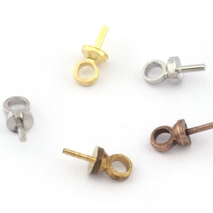 May include: Four different colored metal bead tips with a loop and a post. The bead tips are gold, silver, bronze, and brass.