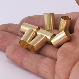 May include: A close-up of six gold-coloured metal tubes, likely for crafting or jewellery making.
