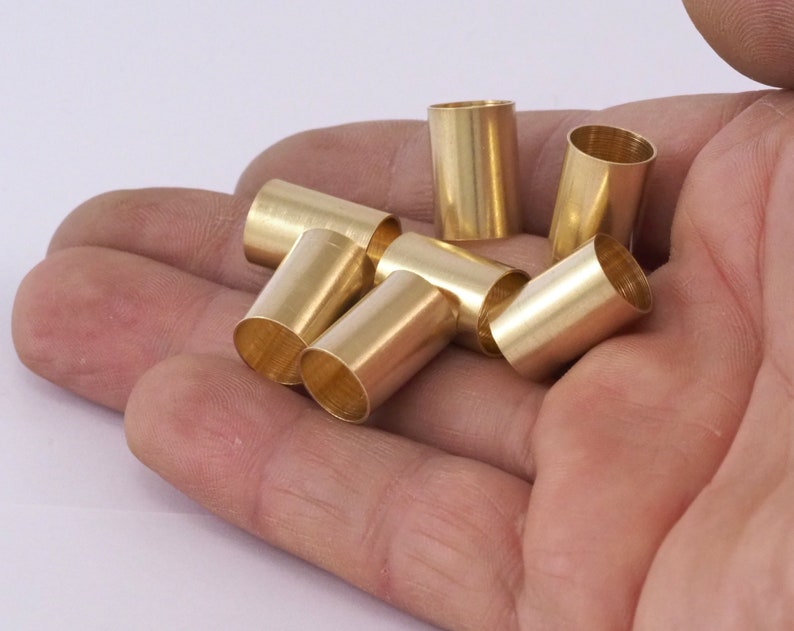 May include: A close-up of six gold-coloured metal tubes, likely for crafting or jewellery making.