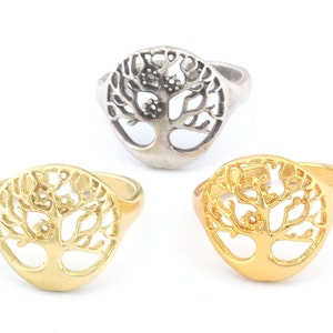 May include: Three rings with a tree of life design. One ring is silver, one is gold, and one is a darker gold.