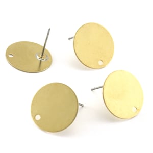 May include: Four gold-colored round earring blanks with a small hole in the center. Each blank has a post attached to the back.