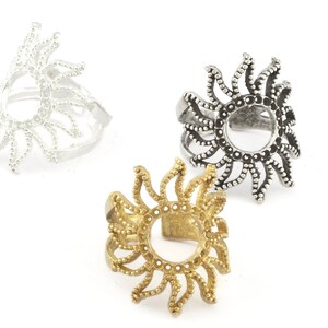 May include: Three adjustable rings with a sun design. The rings are silver, gold, and antique silver.