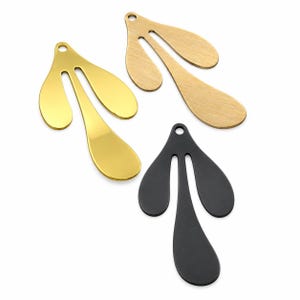May include: Three metal leaf-shaped pendants with a single hole at the top for suspension. One pendant has a polished gold finish, one has a brushed gold finish, and one has a matte black finish. Each piece features a three-lobed design.