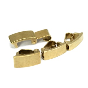 May include: Three gold-toned metal watch band links. The links are designed to connect to each other to form a watch band.