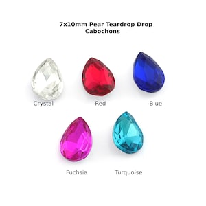 May include: Five pear-shaped cabochons in crystal, red, blue, fuchsia, and turquoise. Each gemstone measures 7x10mm. The gemstones are displayed on a white background. The image includes the text "7x10mm Pear Teardrop Drop Cabochons".