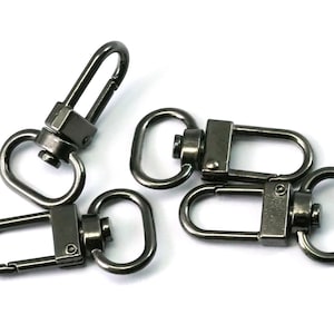 May include: Four black metal swivel clasps with a spring-loaded gate. These clasps are commonly used for attaching straps, leashes, or other accessories.