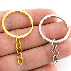 May include: Two keychains, one gold and one silver, with a small chain attached to each.