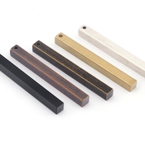 May include: Five metal bar pendants in different finishes: black, bronze, copper, gold, and silver. Each bar has a small loop at the top for hanging.
