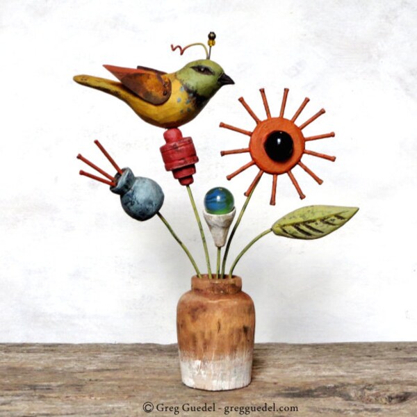 Folk art bird on flowers sculpture