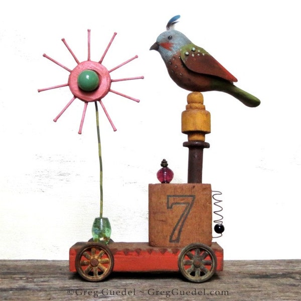 Folk art sculpture with carved wood bird and flower