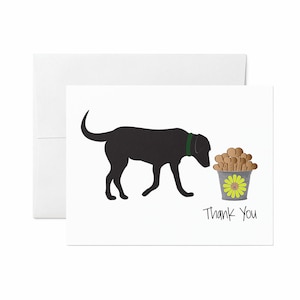May include: White greeting card with a black silhouette of a Labrador Retriever wearing a green collar. The card features a bucket of dog treats and the words "Thank You" in black text. A white envelope is included.