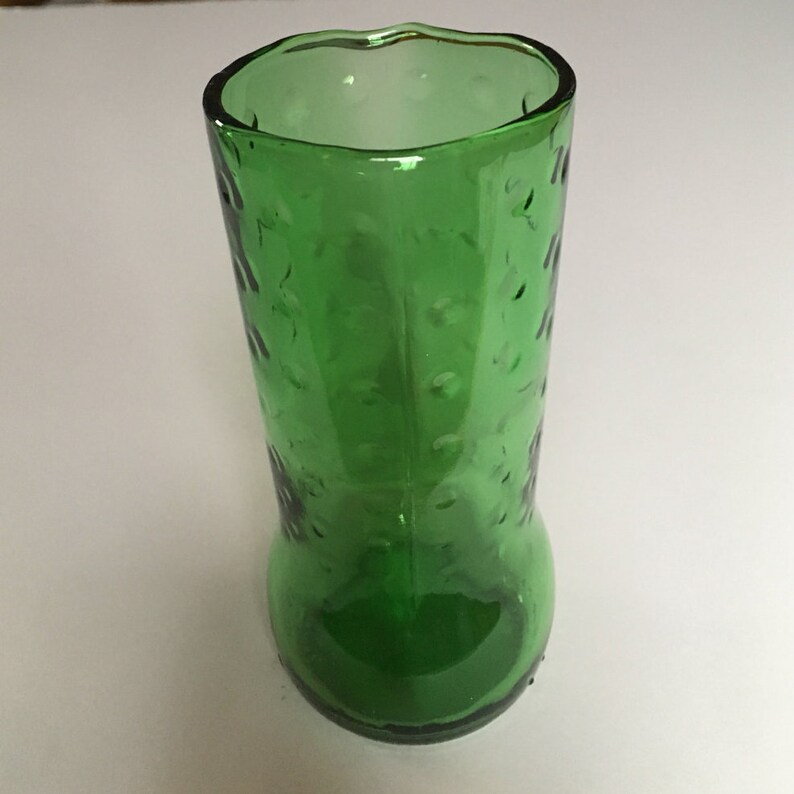May include: A green glass vase with a textured surface. The vase is made from a recycled glass bottle.