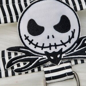 May include: Black and white striped fabric with an embroidered patch of Jack Skellington from The Nightmare Before Christmas.