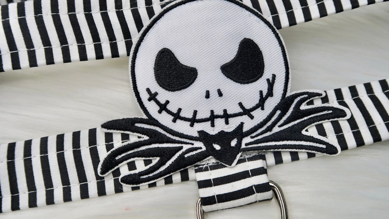 May include: Black and white striped fabric with an embroidered patch of Jack Skellington from The Nightmare Before Christmas.
