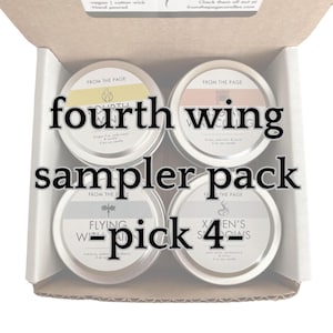May include: A sampler pack of four 2 oz soy candles in a cardboard box. The candles are labeled "Fourth Wing", "Flying With The Rain", "Xena's Shadows", and "Dragon Fire Underwoods".
