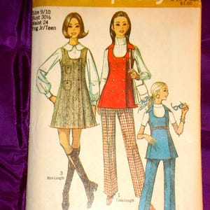 May include: A Simplicity sewing pattern envelope 8916 featuring illustrations of three outfits: a herringbone mini-dress, a red double-breasted tunic with patterned trousers, and a blue tunic with matching pants. Text includes Simplicity 8916.