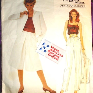 May include: A Vogue Patterns American Designer sewing pattern envelope, number 2923, featuring Edith Head designs. The cover displays illustrations of a white blazer, a dark red top, white culottes, and white trousers, with a Vogue American Designer Original label.
