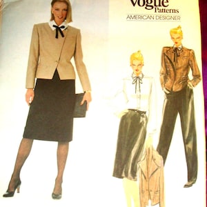 May include: A Vogue Patterns American Designer sewing pattern envelope by Bill Blass, number 2764. The cover features illustrations of outfits including a tan blazer, black skirt, white blouse with a black bow tie, and dark trousers.