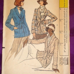 May include: Vogue Patterns sewing pattern envelope featuring illustrations of three women in belted jackets. The envelope includes the text "Vogue Patterns", "Size 12", and "Bust 34". The price is listed as $2.00.
