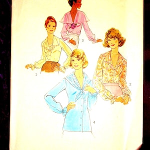 May include: A Simplicity 7234 sewing pattern envelope for a size 14, 36-inch bust miss blouse. The cover features illustrations of four long-sleeved blouse variations with collars, ruffles, and button-front closures in various colors and patterns.