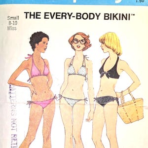 May include: A vintage Simplicity sewing pattern for "THE EVERY-BODY BIKINI." The pattern envelope features illustrations of three bikini designs. The top of the envelope has the number 6947 and the Simplicity logo. The pattern is sized for small, 8-10 Miss.