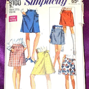May include: A Simplicity sewing pattern envelope, number 8100, featuring illustrations of six skirt designs in various colors and patterns, including solid blue, red, yellow, blue and white gingham, red plaid, and a blue floral print on white.