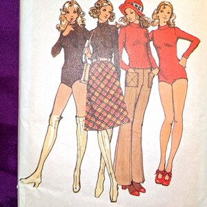 May include: A vintage Simplicity sewing pattern envelope 9562 for size 12, bust 34, waist 25.5 inches. The illustration shows four figures wearing knit body-suits, a plaid skirt, and flared trousers in various colors including red and brown.