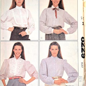 May include: A vintage McCall's sewing pattern featuring four blouse designs. The blouses have various details, including ruffled collars, bow ties, and button-down fronts. The pattern includes the text "MCCALL'S" and "Blouses only."
