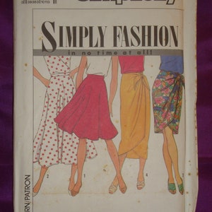 May include: A vintage Simplicity sewing pattern envelope. The cover features the text "SIMPLY FASHION in no time at all!" and illustrations of four different skirt styles. The pattern number is 9626, size U5 (16-24).