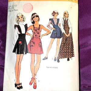 May include: Vintage Simplicity sewing pattern 5210 for young junior/teen sizes. The pattern features illustrations of four different jumper or overall dress designs. The pattern includes the text "Size 11/12 Bust 32".