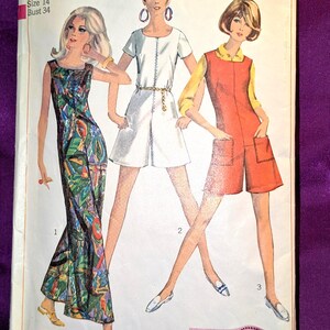 May include: Vintage Simplicity sewing pattern featuring three women's fashion designs. The pattern includes a long dress, a white romper with a gold belt, and an orange jumpsuit. The text on the pattern reads "7000 Simplicity", "Miss Size 14 Bust 34", and "Simple-to-Sew".