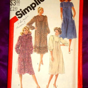 May include: A vintage Simplicity sewing pattern featuring illustrations of four different dress designs. The pattern envelope is red and white, with the Simplicity logo and text indicating size and price. The designs include dresses with various sleeve lengths and necklines.