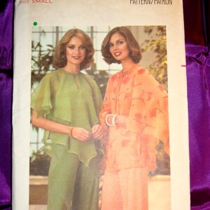 May include: A vintage Butterick sewing pattern featuring two women modeling outfits. One woman wears a green ensemble, the other an orange floral outfit. The pattern is size small, with the text "Butterick THE FASHION ONE" at the top.