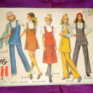 May include: Vintage Simplicity sewing pattern packet featuring illustrations of women in 1970s fashion. The packet includes patterns for tunic-length, mini-length, and midi-length dresses and pantsuits. The packet is labeled "Jiffy" and includes size and measurement information.