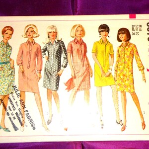 May include: Vintage Simplicity sewing pattern 6970 featuring six women's dress designs. The pattern includes a size 10 with a 31-inch bust. The cover art showcases the dresses in various colors and patterns, including floral, polka dot, and gingham.