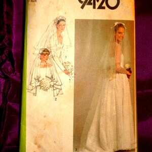 May include: Vintage Simplicity sewing pattern 9420 for a wedding dress. The pattern envelope features illustrations of brides in wedding gowns and veils. The envelope is off-white with green trim and the text "Simplicity 9420".