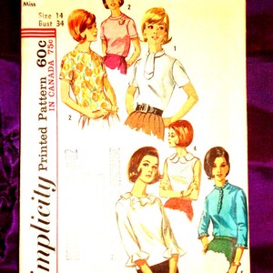 May include: A Simplicity sewing pattern envelope 5885 for a miss size 14 with a 34 inch bust. The front features illustrations of five different blouse styles, including options with ruffled collars, short sleeves, and various necklines.