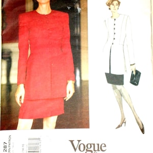 May include: A red two-piece suit with a long-sleeved jacket and a matching skirt. The image also features a Vogue pattern with a drawing of a similar outfit. The pattern is labeled "Scaasi" and "Vogue American Designer."