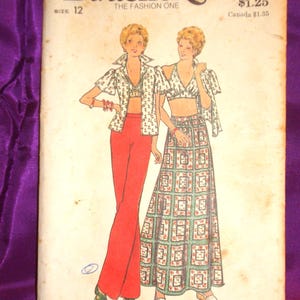 May include: Vintage Butterick sewing pattern, size 12, featuring illustrations of a two-piece outfit: a crop top and pants, and a crop top and long skirt. The pattern includes the text "Butterick" and "THE FASHION ONE".