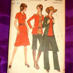 May include: Vintage sewing pattern featuring three illustrated women's fashion designs. The pattern includes a red skirt suit, a red jacket with patterned shirt and green pants, and a green coat with a red shirt and green pants. The pattern size is 12, with a bust size of 34 inches.