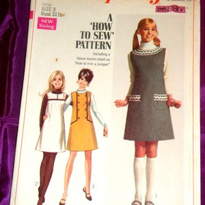 May include: A vintage Simplicity sewing pattern, size 8, for a jumper. The cover features a retro design with illustrations of the finished garment. The pattern includes instructions and a tissue lesson-chart on how to trim a jumper.