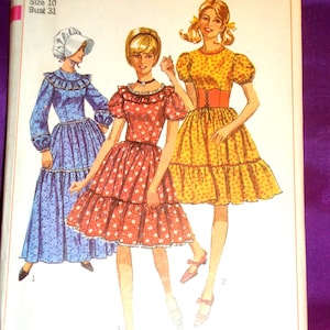 May include: Vintage Simplicity sewing pattern, number 6832, featuring illustrations of three dresses. The dresses are in blue, red, and yellow, with tiered skirts and various sleeve styles. The pattern includes sizing information for Misses, size 10, and bust 31 inches.