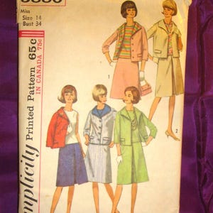 May include: Vintage Simplicity sewing pattern, number 5880, featuring illustrations of women's suits and dresses. The pattern includes a size 14 with a 34-inch bust. The cover is cream-colored with text and illustrations in various colors.