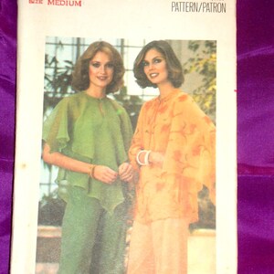 May include: Vintage Butterick sewing pattern 5341, size medium. The pattern features two women modeling outfits. One outfit is green, and the other is orange. The pattern's cover has the Butterick logo and the text "PATTERN/PATRON".
