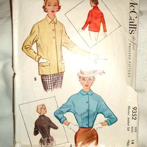 May include: A vintage McCall's printed pattern envelope for a jacket set, number 9352, size 14. The front features illustrations of two jacket styles: one in yellow with a collar and one in blue with a rounded collar, both worn with white gloves.